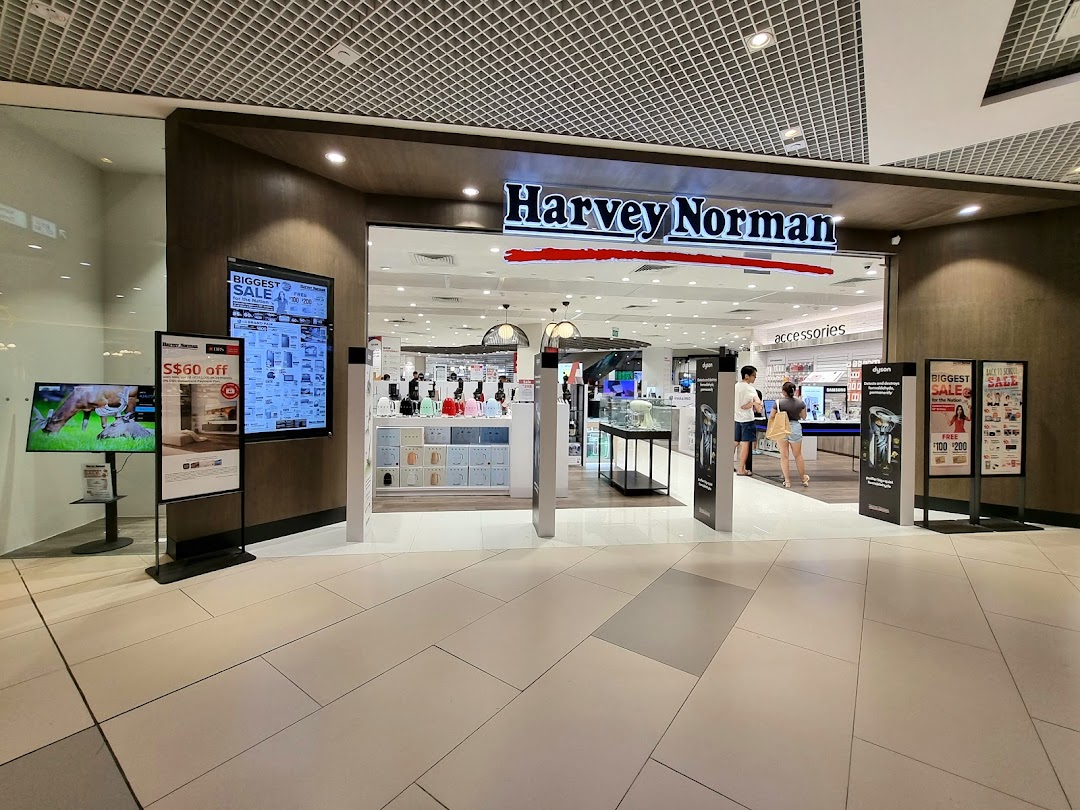 The entrance of Harvey Norman at Westgate Mall, featuring promotional displays and a clear view into the store.