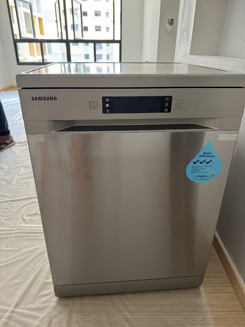 A new Samsung dishwasher with a water efficiency sticker, ready for installation in a modern home.