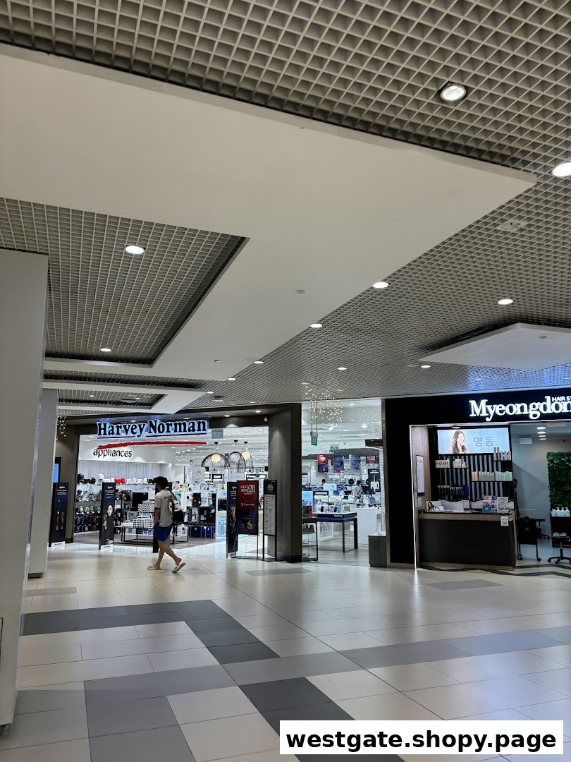 The entrance of Harvey Norman Appliances and Myeongdong Hair Style within a shopping mall corridor.