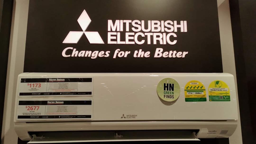 A Mitsubishi Electric air conditioner display with price tags and energy efficiency ratings at Harvey Norman.