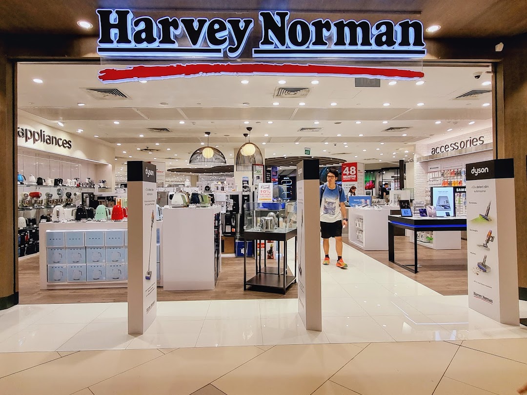 The brightly lit entrance of Harvey Norman, showcasing a wide array of home appliances and electronics.
