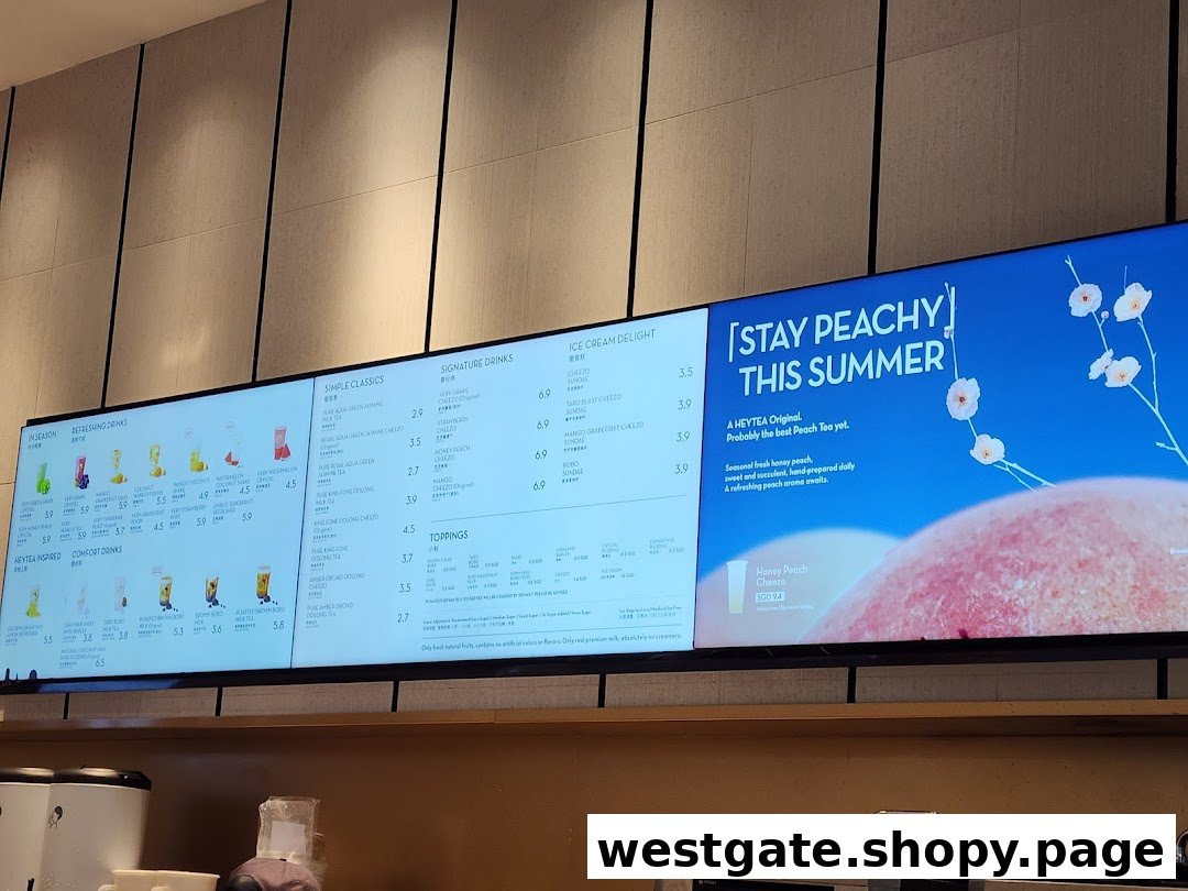 Digital menu boards displaying a variety of tea, fruit drinks, and ice cream options with prices.