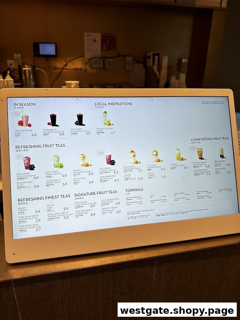 A digital menu board displaying a wide variety of fruit teas, milk teas, and toppings from HEYTEA.