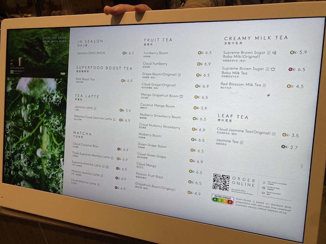 A digital menu board displaying various tea and beverage categories with prices at HEYTEA.
