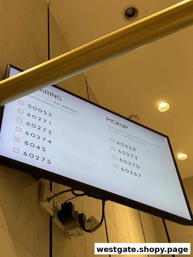 A digital screen at HEYTEA displaying order numbers for preparing and pickup.