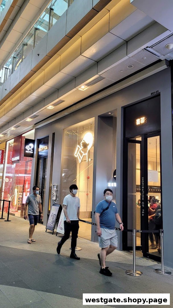 The modern storefront of HEYTEA at Westgate, with shoppers passing by.
