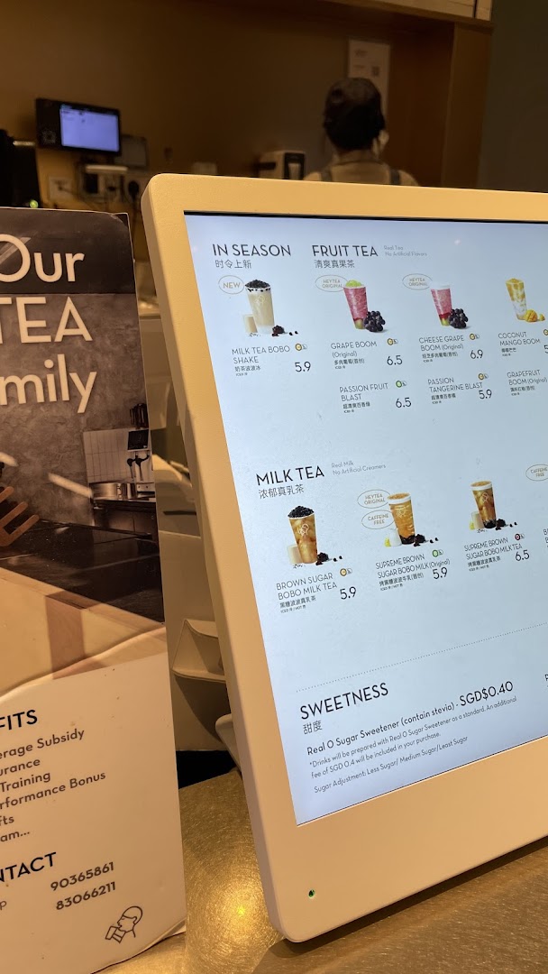 A digital menu board displaying various tea beverages and pricing at HEYTEA.