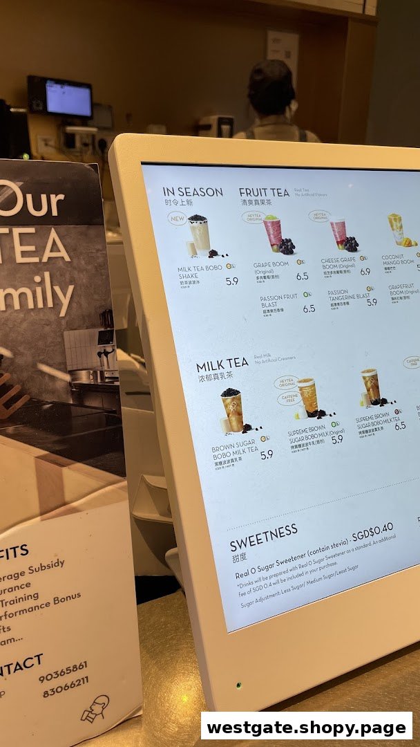 A digital menu board displaying various tea beverages and pricing at HEYTEA.