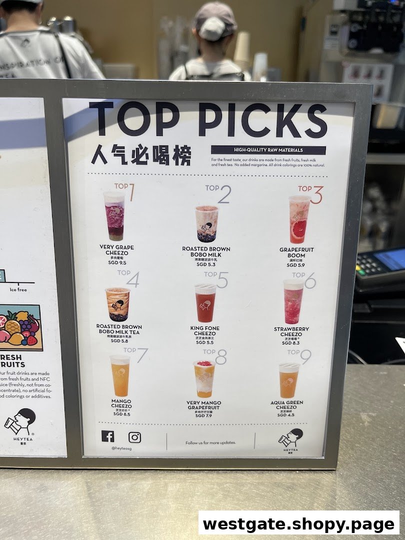 A display board showcasing HEYTEA's 'Top Picks' menu with various fruit and milk tea beverages.