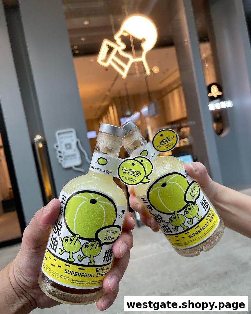 Two hands holding HEYTEA Emblic Superfruit Series bottled drinks with the shop interior in the background.
