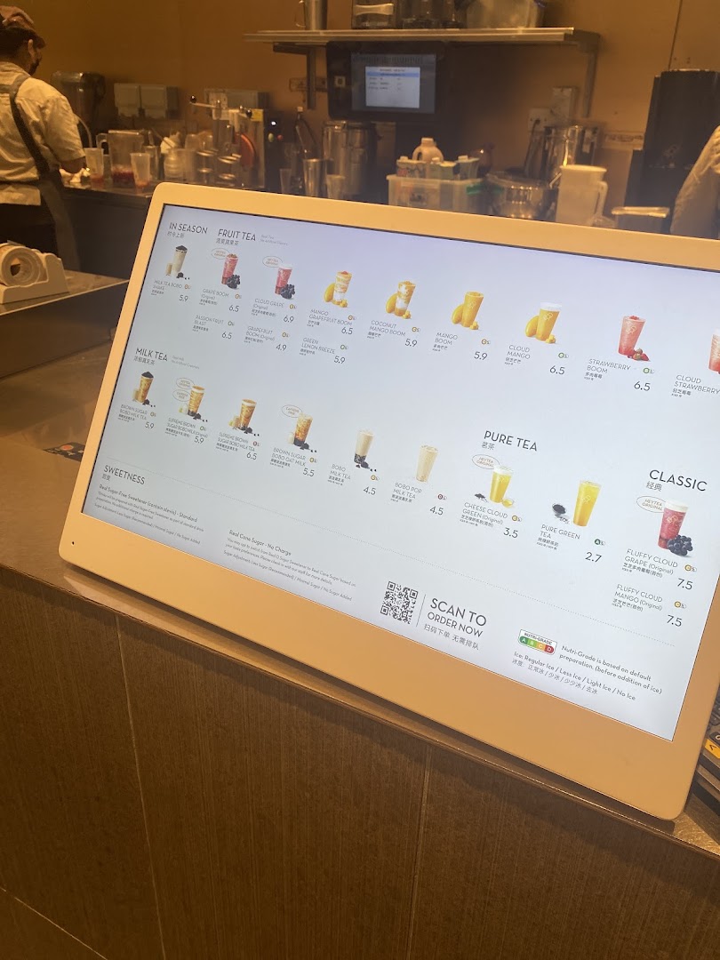 A digital menu display at HEYTEA showcasing various fruit teas, milk teas, and pure teas.