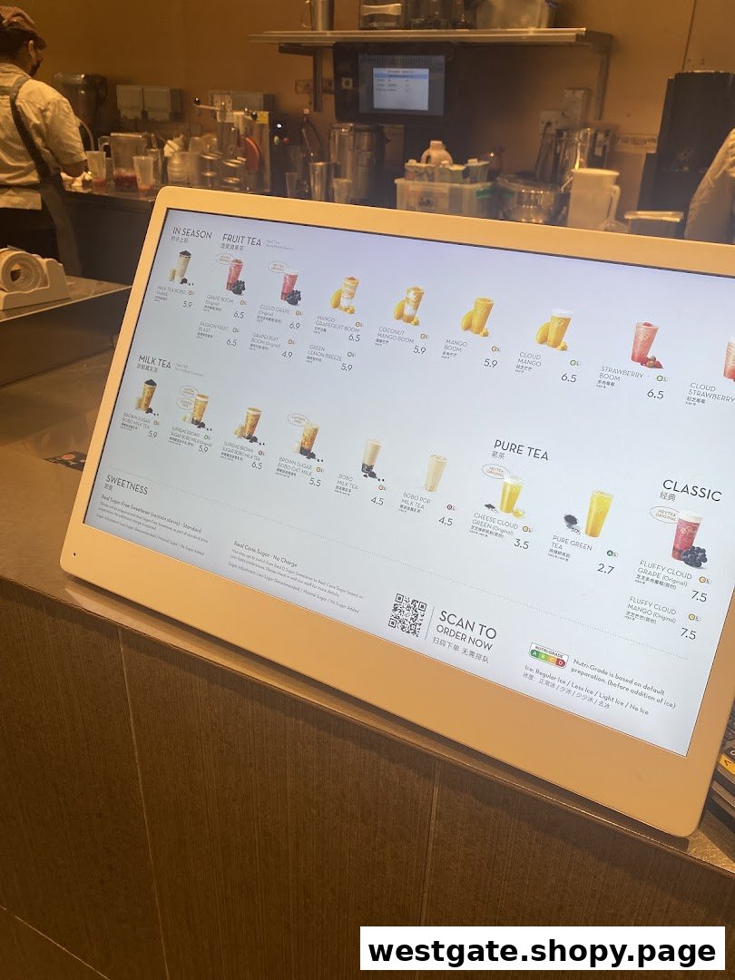 A digital menu display at HEYTEA showcasing various fruit teas, milk teas, and pure teas.