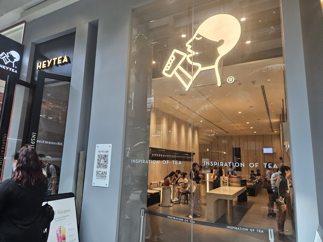 The modern storefront of HEYTEA Westgate, showcasing its inviting interior and iconic logo.