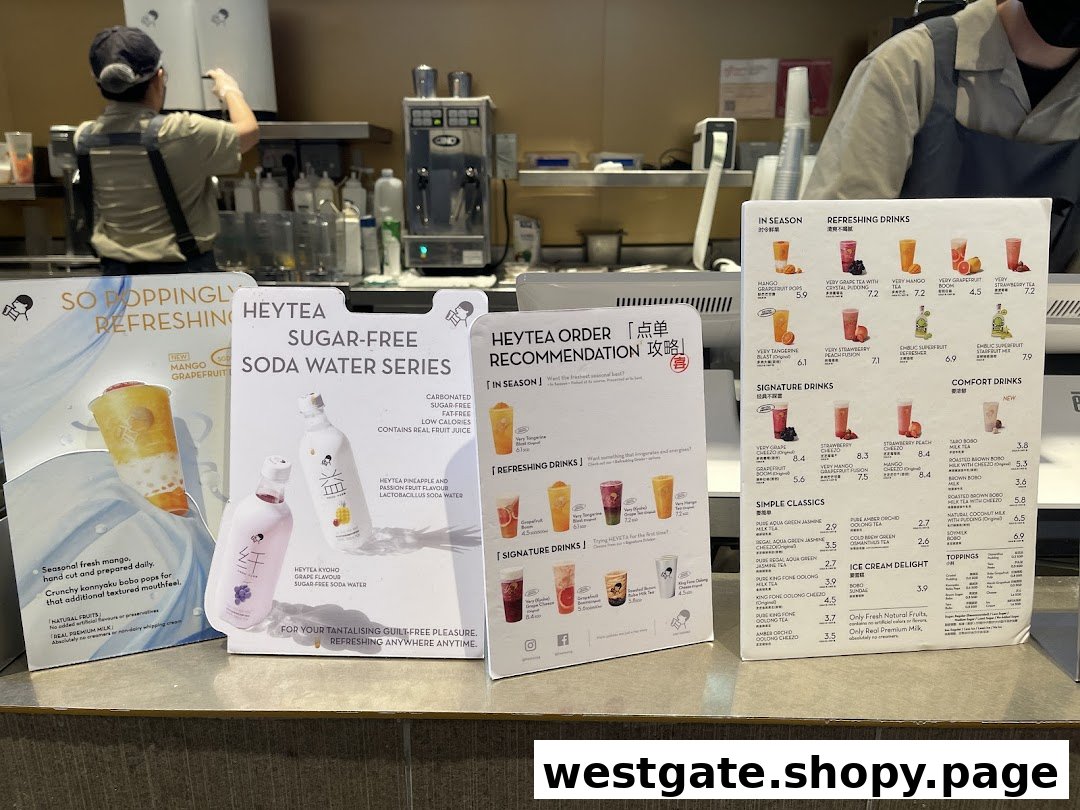 A counter view of HEYTEA with various drink menus, promotional displays, and staff preparing beverages.