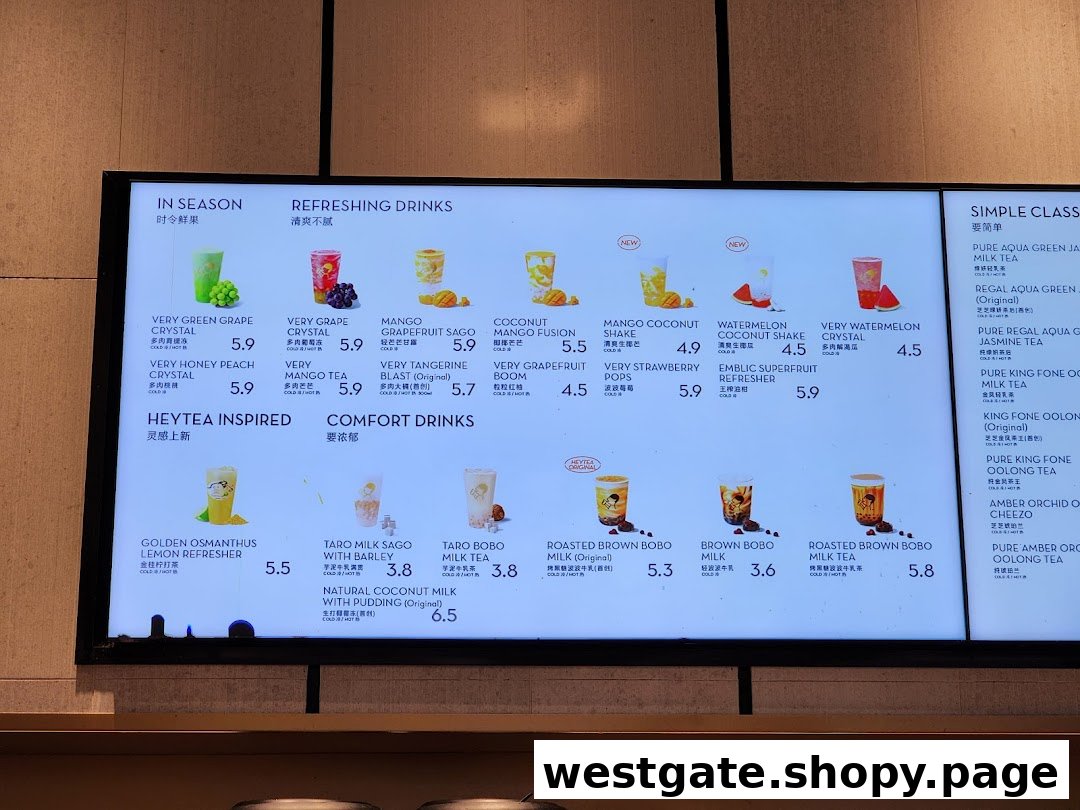 A digital menu board displaying various fruit teas, milk teas, and refreshing drinks with prices.