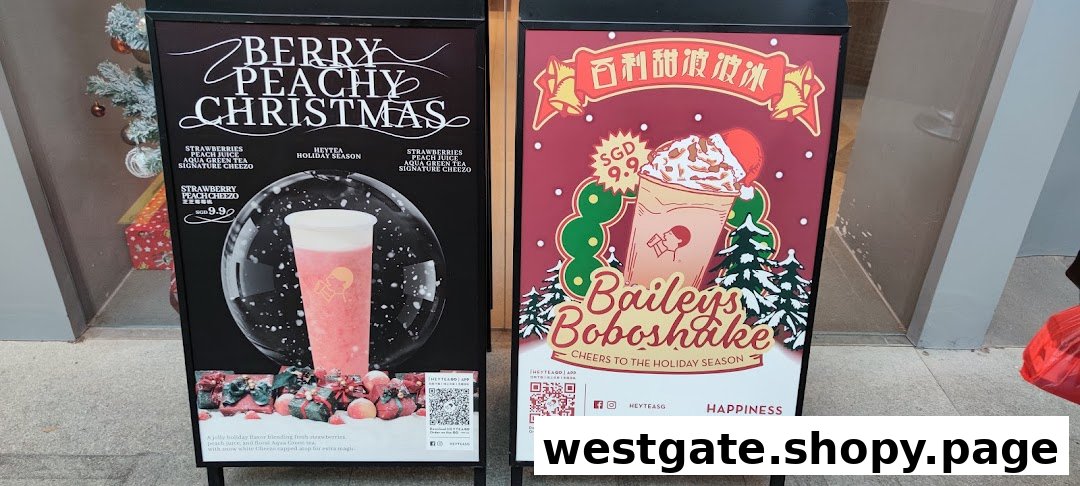 Two A-frame signs promoting HEYTEA's festive 'Berry Peachy Christmas' and 'Baileys Boboshake' drinks.
