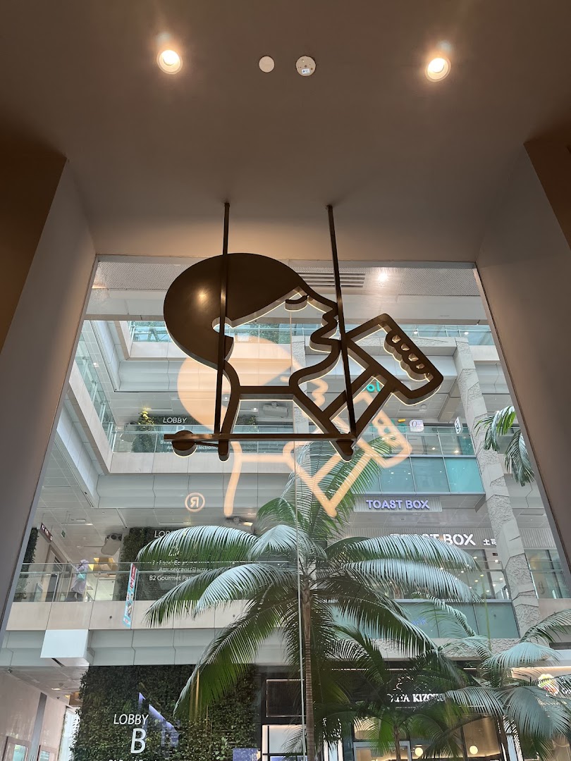 View from inside HEYTEA, showcasing the mall atrium with a unique decorative art piece.