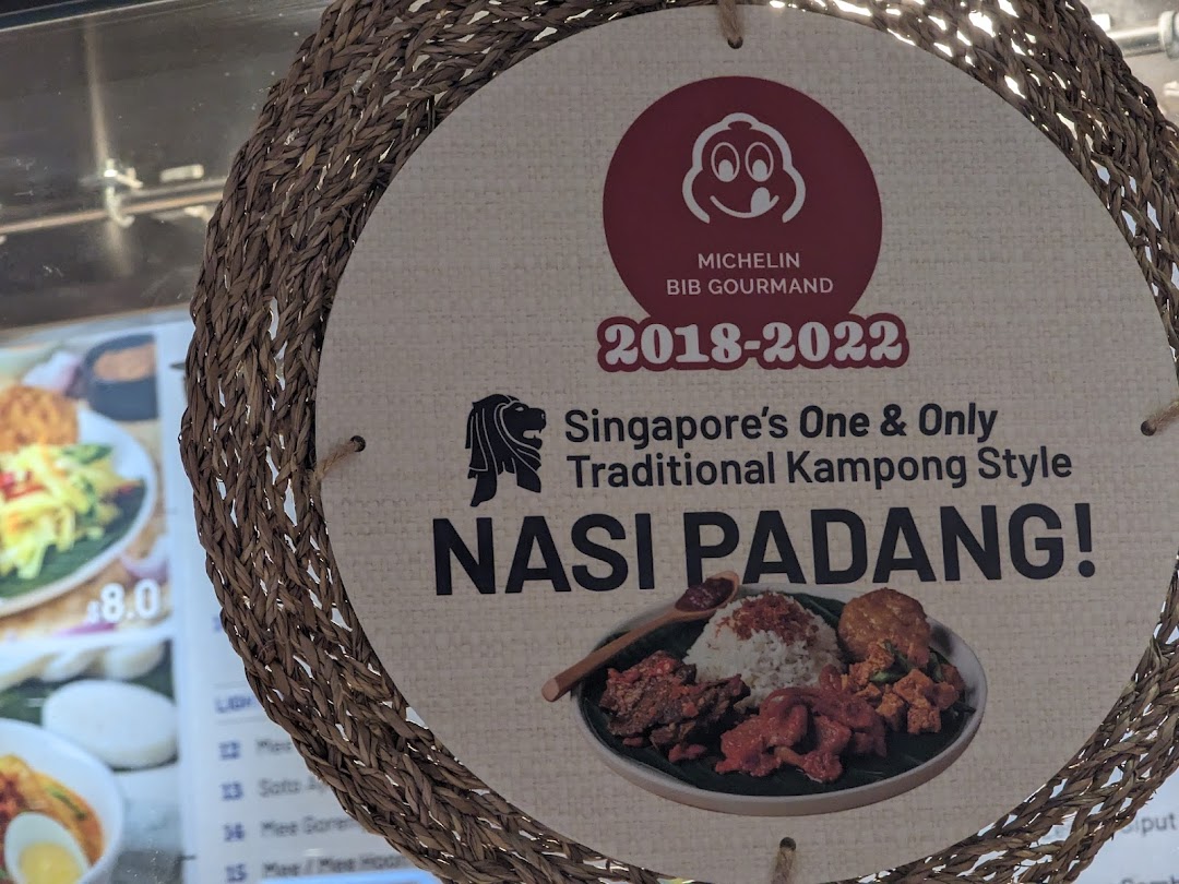 A woven sign promotes Hjh Maimunah's Michelin Bib Gourmand-awarded traditional Kampong Style Nasi Padang.