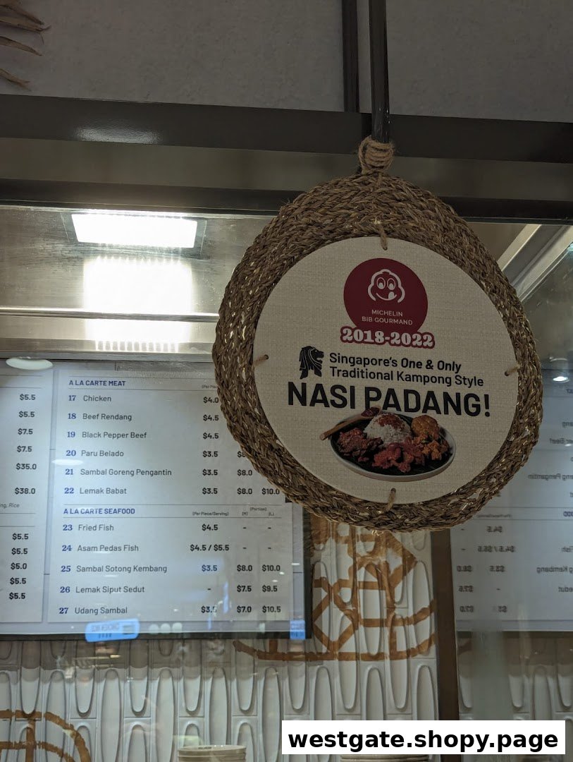 A digital menu board displaying A La Carte meat and seafood dishes, alongside a promotional sign for Nasi Padang.