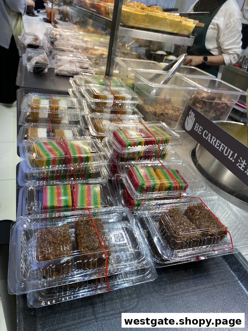 A vibrant display of pre-packaged traditional Malay kueh and other delights at Hjh Maimunah Mini.