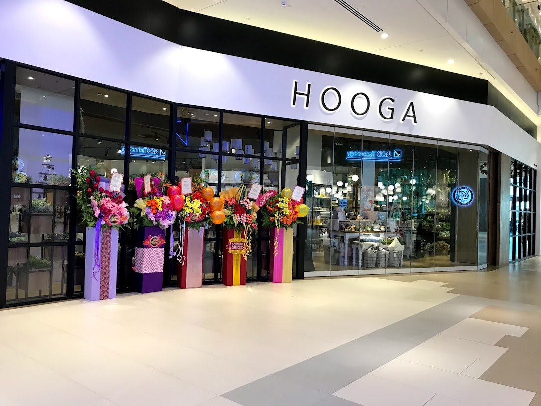 The HOOGA shop entrance at Westgate, adorned with vibrant grand opening flower arrangements.
