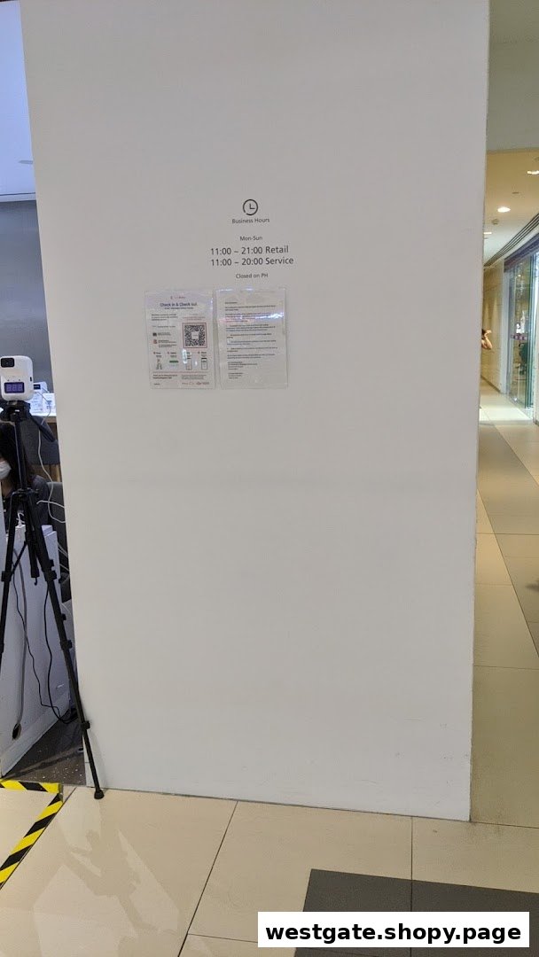 A wall displaying Huawei Experience Store's business hours and check-in information.