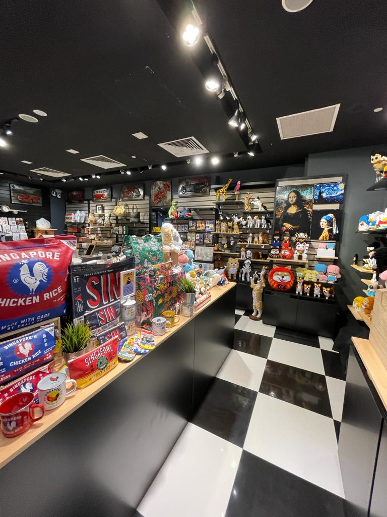 An interior view of Hyggerium, a vibrant souvenir and gift shop with unique Singapore-themed items.