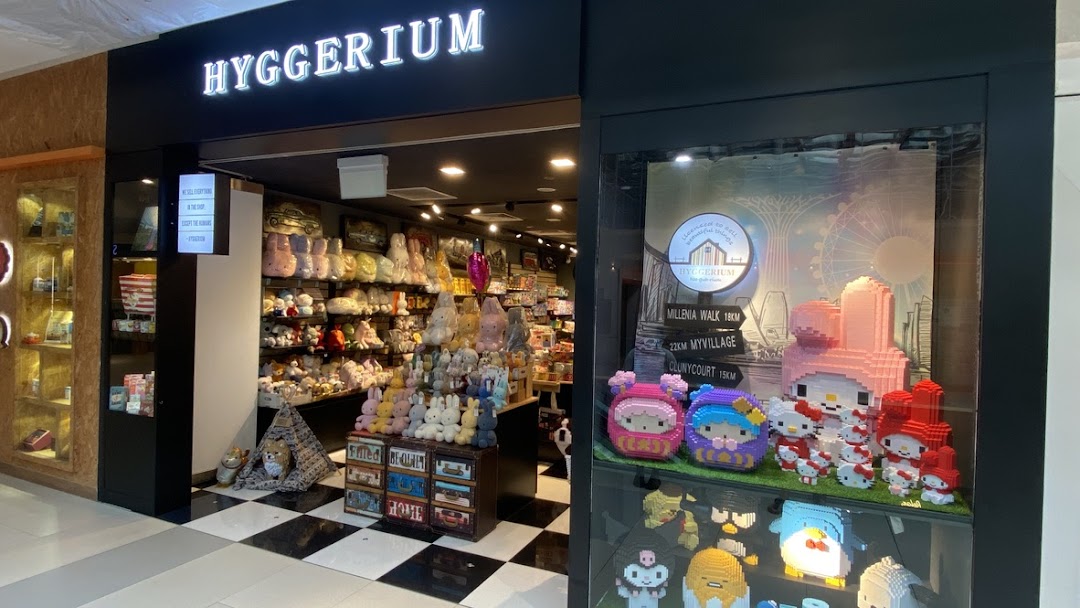 The storefront of Hyggerium, featuring a display window with pixel art characters and a view of the plush toy-filled interior.