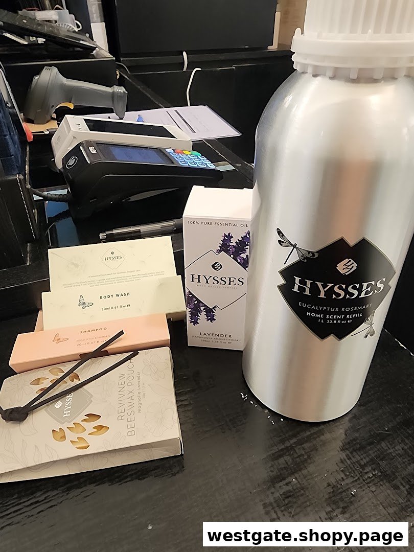 Various HYSSES home scent and personal care products, including essential oils and body wash, displayed near a payment terminal.