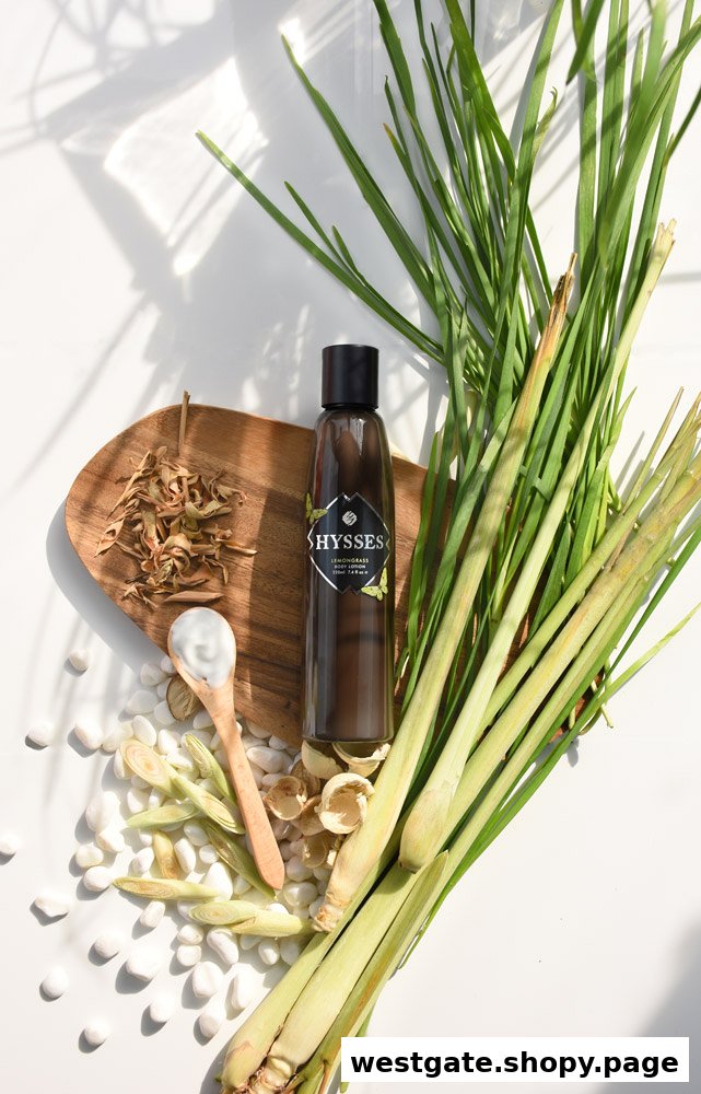A HYSSES lemongrass product bottle displayed with fresh lemongrass, dried botanicals, and white stones.