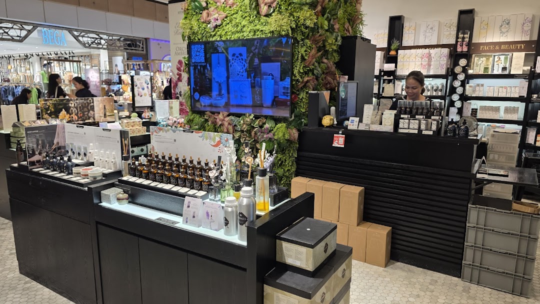 Interior view of HYSSES - Home Scents, showcasing various aromatherapy products and a staff member.