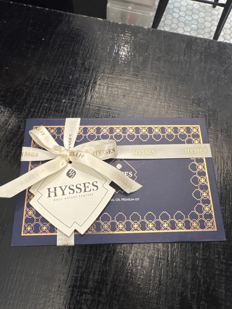 A beautifully packaged dark blue gift box from HYSSES, tied with a cream ribbon and tag.