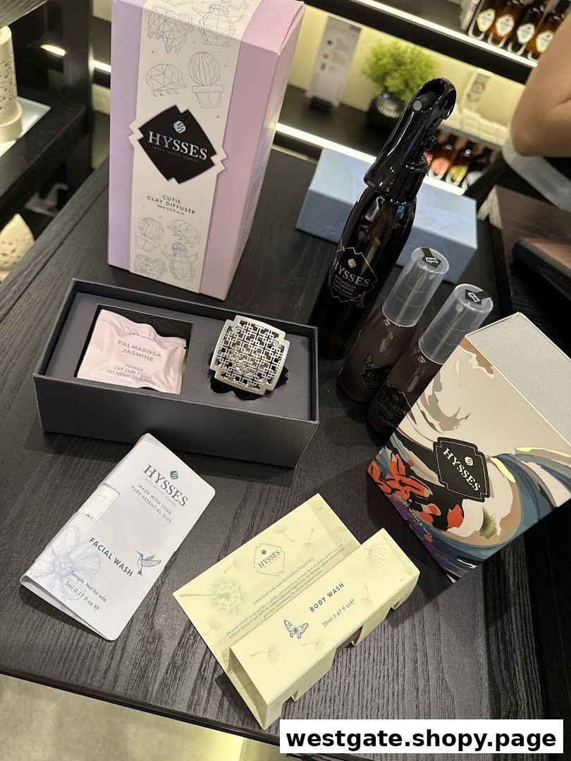 Various HYSSES home scents and personal care products displayed on a dark surface.