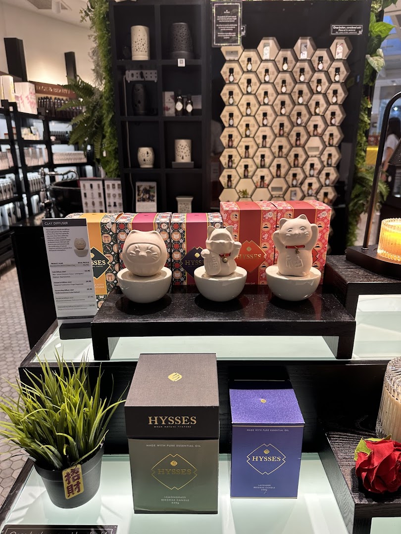 An interior shot of HYSSES - Home Scents, showcasing diffusers, essential oils, and candles.