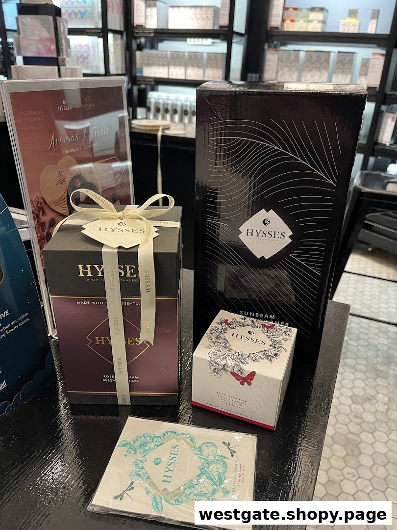 A display of HYSSES home scent products, including candles and diffusers, with a promotional sign.