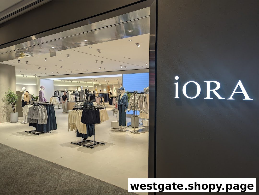 The entrance of iORA Westgate, showcasing a brightly lit interior with modern women's clothing on display.