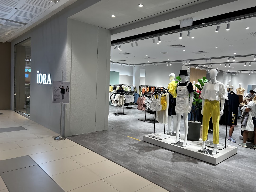 The entrance of iORA fashion store, showcasing modern clothing displays and mannequins.