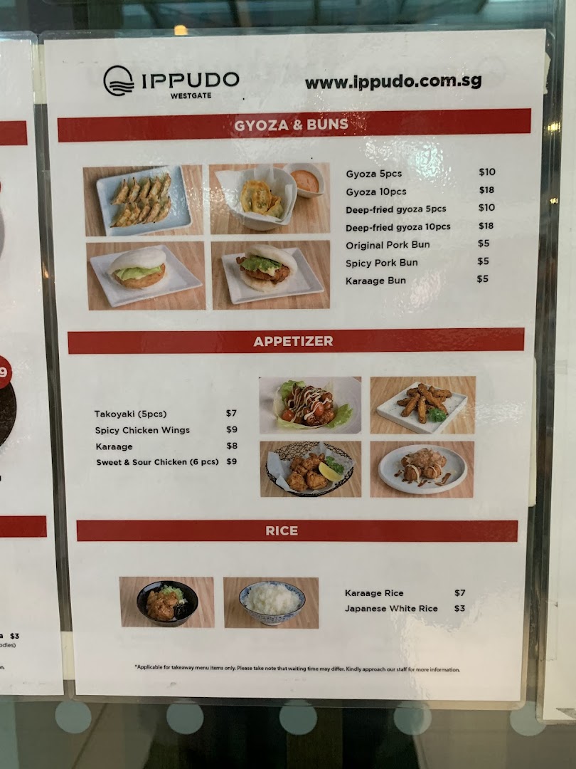 A detailed menu board from IPPUDO WESTGATE, showcasing various Japanese appetizers, gyozas, buns, and rice dishes with prices.