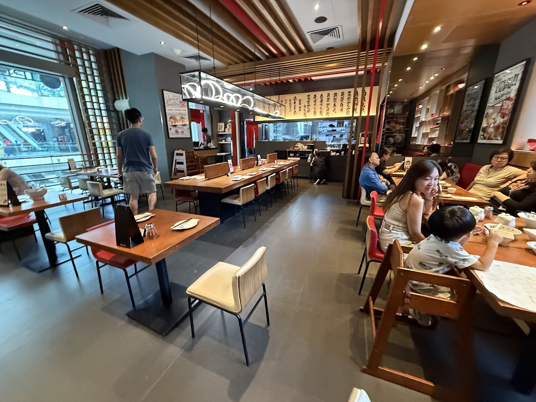 A vibrant interior shot of IPPUDO Westgate, featuring diners enjoying meals in a modern setting.