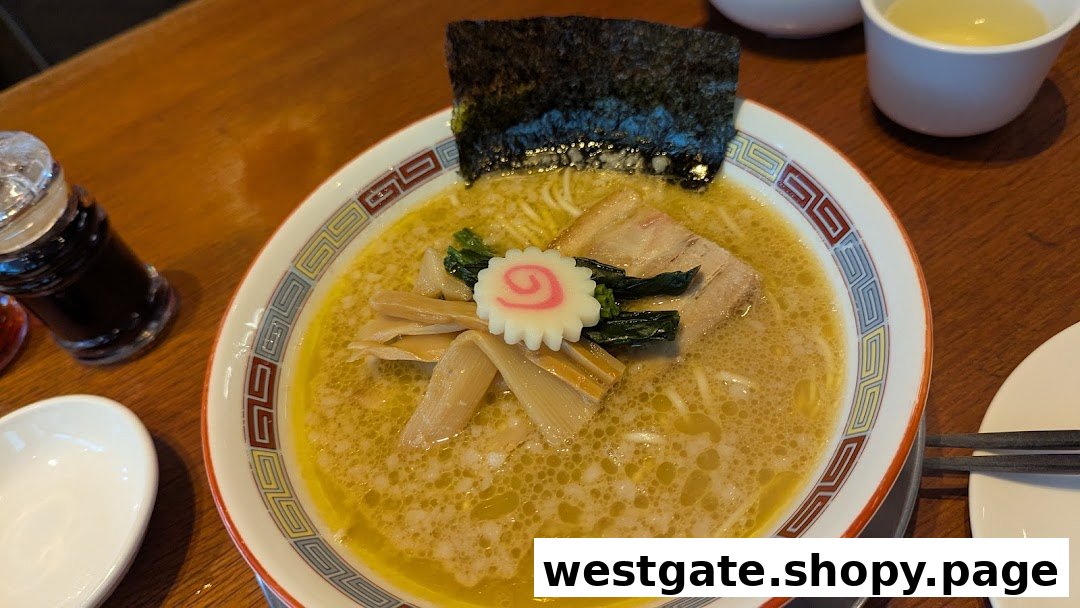 A close-up of a delicious bowl of ramen with pork, seaweed, and fish cake.