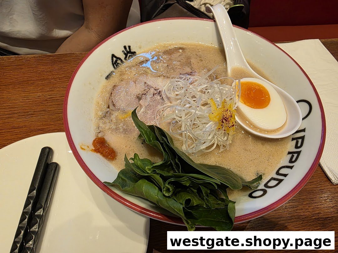 A close-up of a delicious bowl of ramen from IPPUDO, featuring pork, egg, and fresh greens.