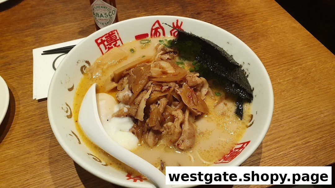A close-up of a delicious bowl of ramen with pork, egg, and seaweed on a wooden table.