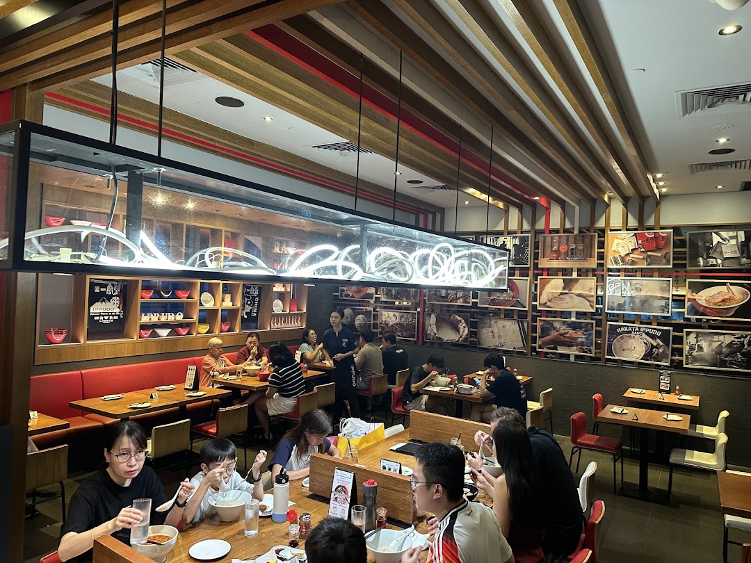 Diners enjoy authentic ramen in the bustling, modern interior of Ippudo Westgate.