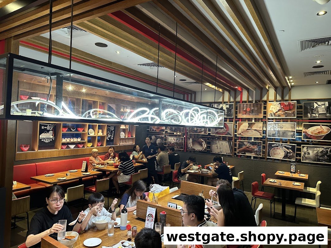 Diners enjoy authentic ramen in the bustling, modern interior of Ippudo Westgate.