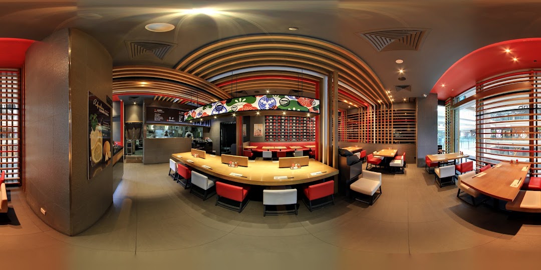 A panoramic view of IPPUDO WESTGATE's modern and inviting ramen restaurant interior with various seating options.