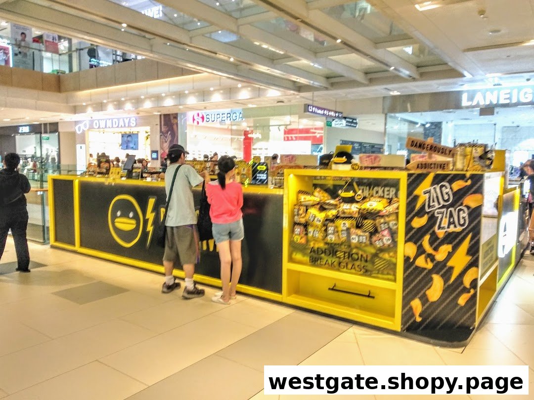 A vibrant black and yellow IRVINS kiosk displaying its signature salted egg snacks in a bustling mall.