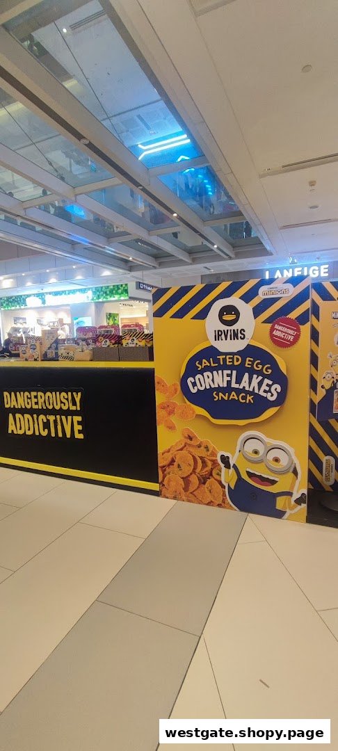 An IRVINS display featuring Minions and Salted Egg Cornflakes snack, with 'Dangerously Addictive' branding.