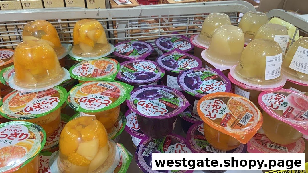 A vibrant display of various fruit jellies and desserts in individual cups, showcasing different flavors.
