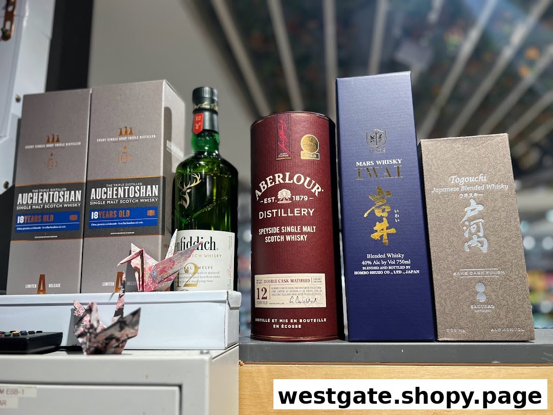 A display of various premium whisky bottles and boxes, including Scotch and Japanese blends.