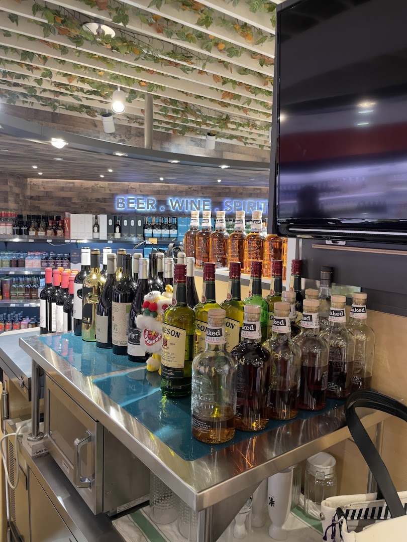 A vibrant display of various beer, wine, and spirit bottles on a counter inside Jays Bar.